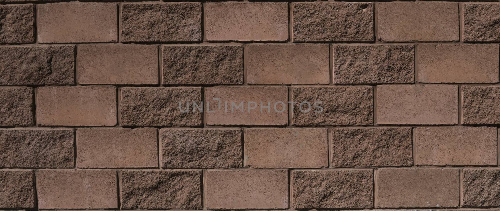 Brown-red walls stone texture lit by bright sunlight. by vovsht
