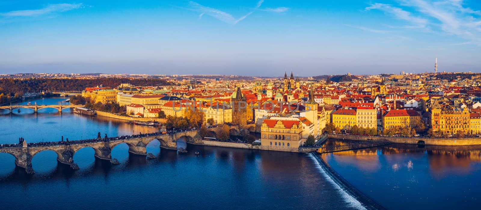 Aerial Prague panoramic drone view of the city of Prague at the Old Town Square, Czechia. Prague Old Town pier architecture and Charles Bridge over Vltava river in Prague at sunset, Czech Republic. 