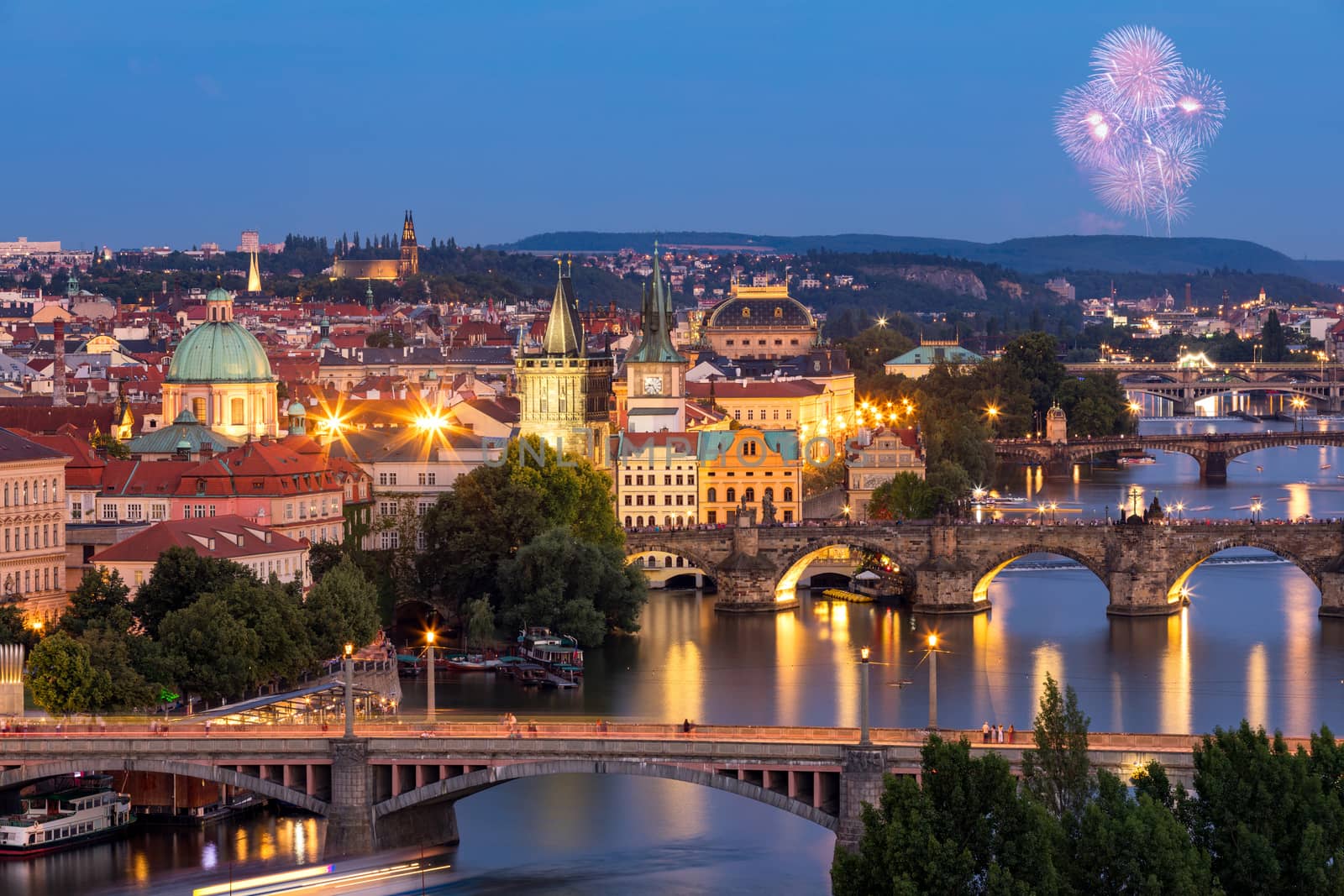 Prague, Czech Republic bridges panorama with historic Charles Bridge and Vltava river at night. Pargue at dusk, view of the Lesser Bridge Tower of Charles Bridge (Karluv Most). Czechia.