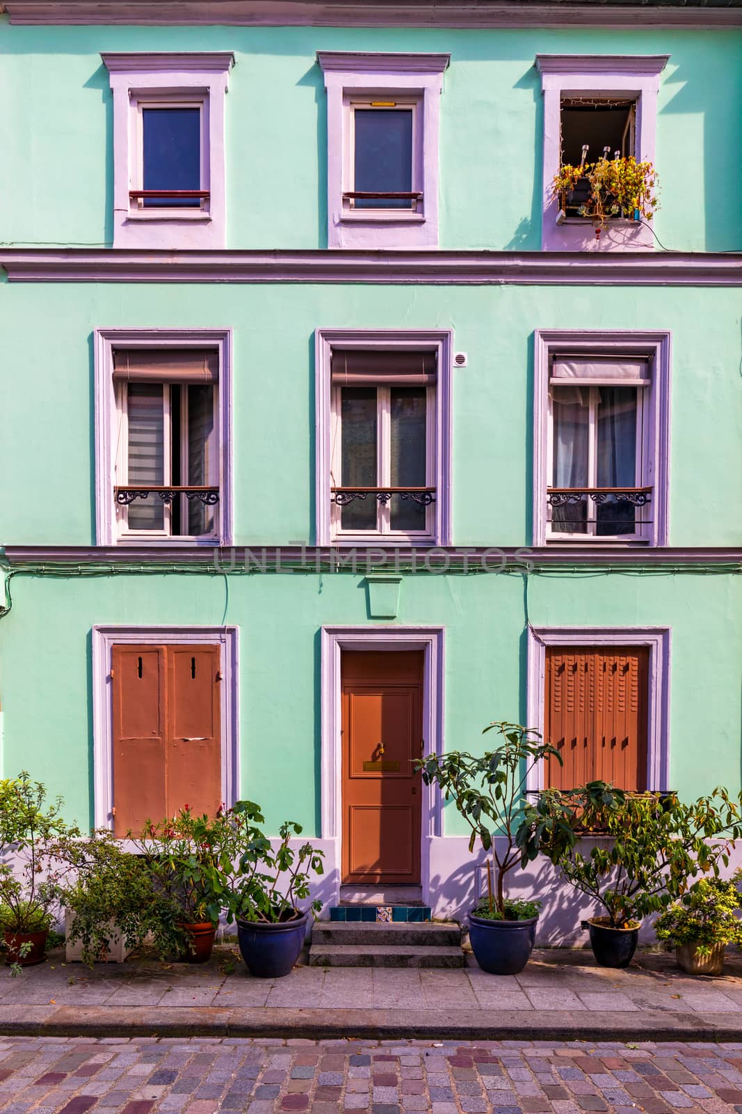 Cremieux Street (Rue Cremieux), Paris, France. Rue Cremieux in the 12th Arrondissement is one of the prettiest residential streets in Paris. Colored houses in Rue Cremieux street in Paris. France.