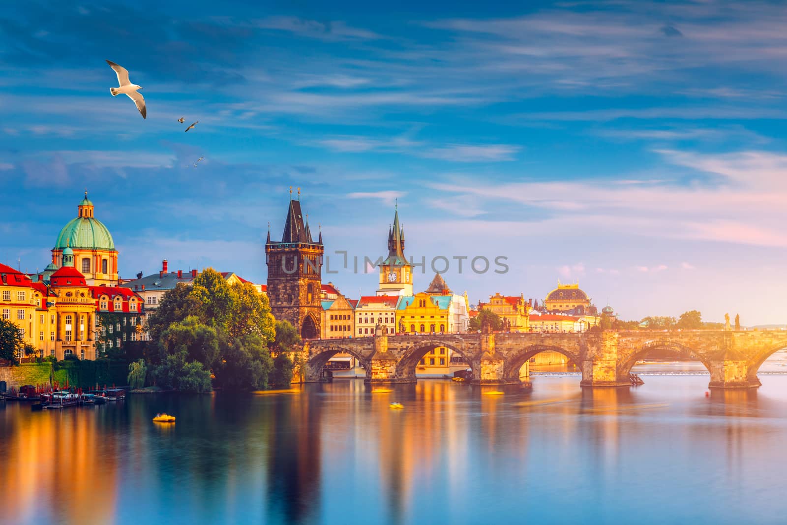 Autumn view to Charles bridge on Vltava river in Prague, Czech Republic. Autumn view to Charles Bridge, Prague old town and Vltava river. Czechia. Scenic autumn view of the Old Town with red foliage.