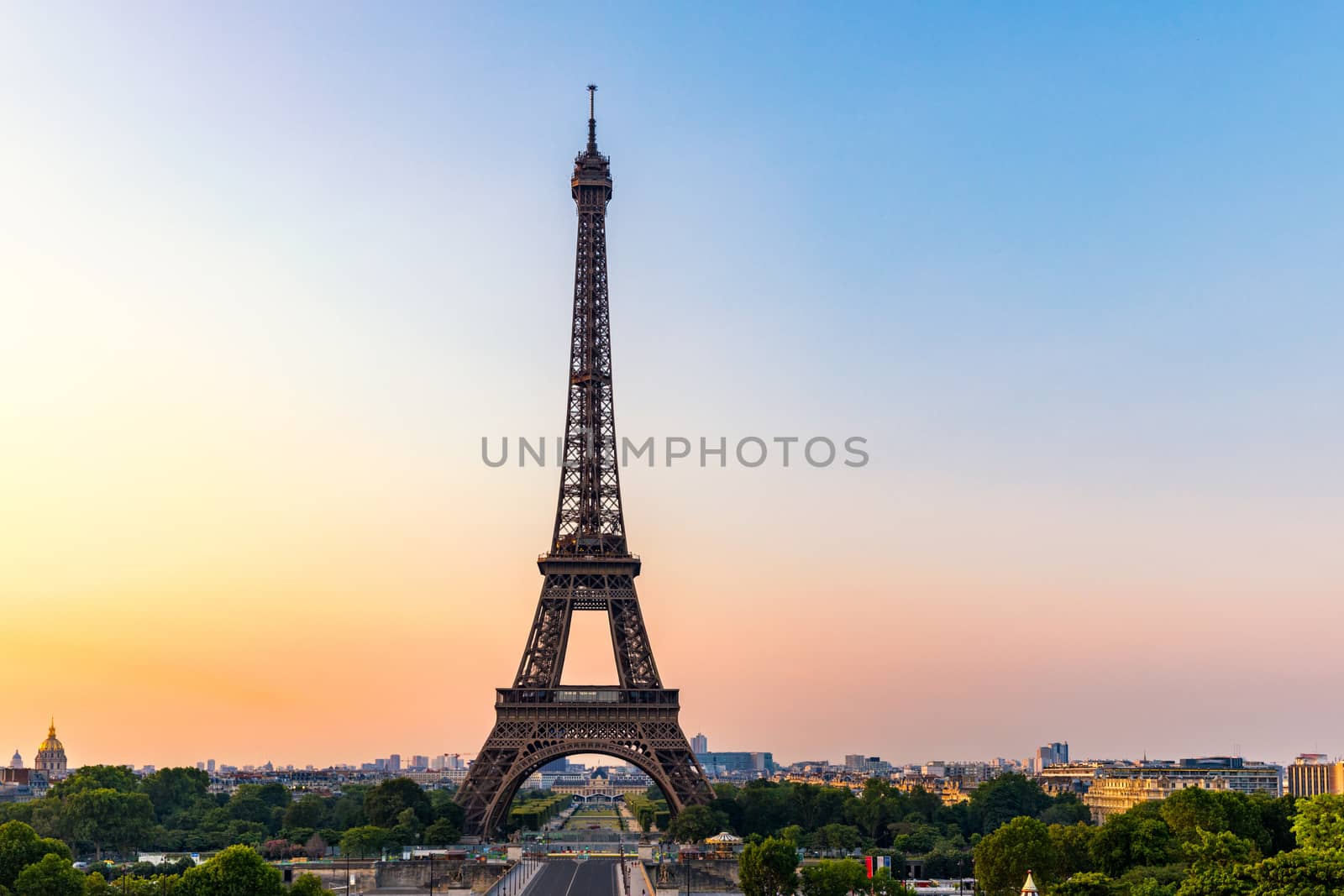 Eiffel tower in summer, Paris, France. Scenic panorama of the Eiffel tower under the blue sky. View of the Eiffel Tower in Paris, France in a beautiful summer day. Paris, France.