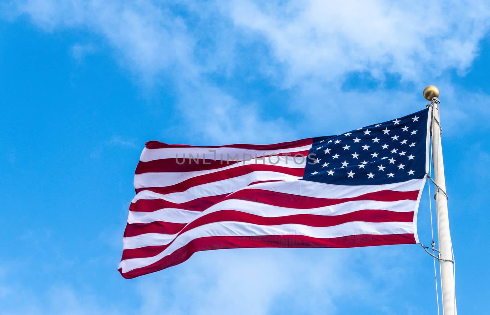 Closeup of flying American flag at Pearl Harbor, Oahu, Hawaii, U by Claudine