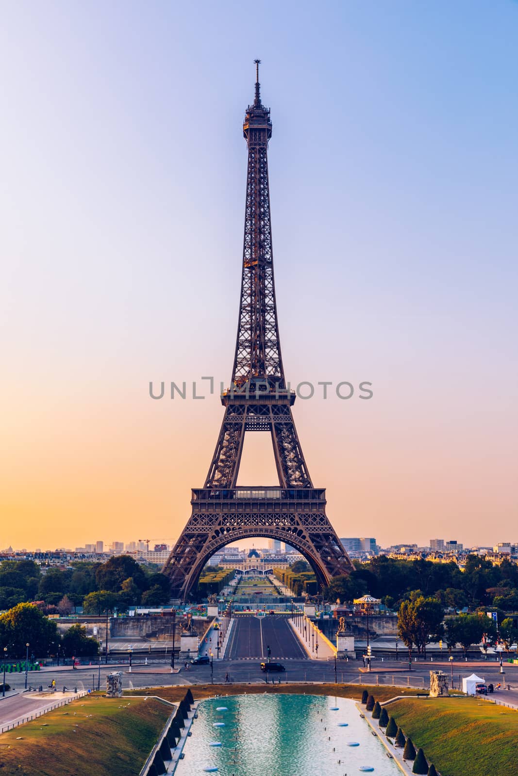 Eiffel tower in summer, Paris, France. Scenic panorama of the Eiffel tower under the blue sky. View of the Eiffel Tower in Paris, France in a beautiful summer day. Paris, France.