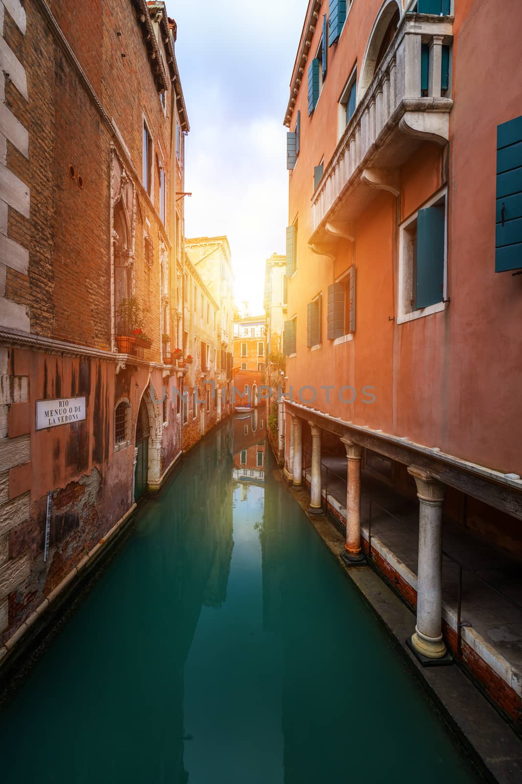 View of the street canal in Venice, Italy. Colorful facades of old Venice houses. Venice is a popular tourist destination of Europe. Venice, Italy.