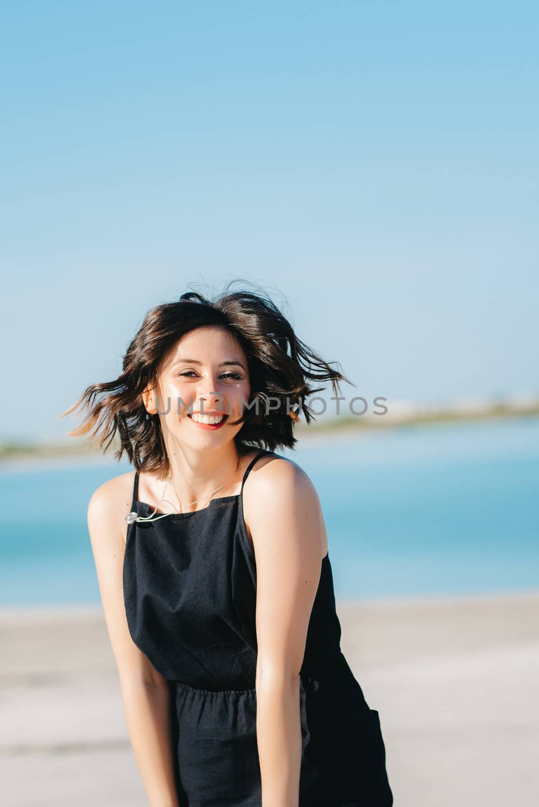 joyous happy girl in a black dress laughs loudly