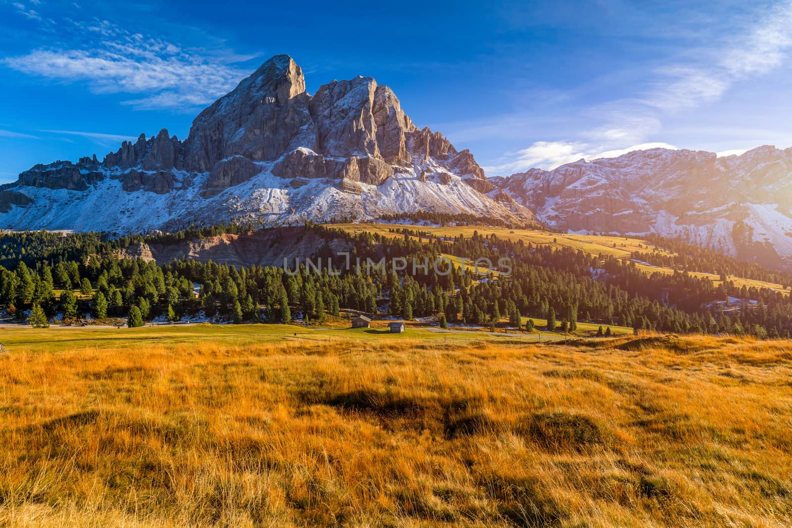 Stunning view of Peitlerkofel mountain from Passo delle Erbe in Dolomites, Italy. View of Sass de Putia (Peitlerkofel) at Passo delle Erbe, with wooden farm houses, Dolomites, South Tyrol, Italy.