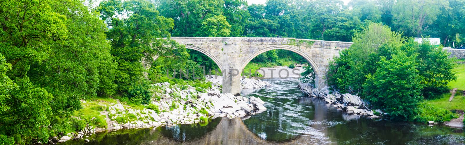 Panorama view of the Devils bridge and River Lune in Kirkby Lonsdale in Cumbria by paddythegolfer