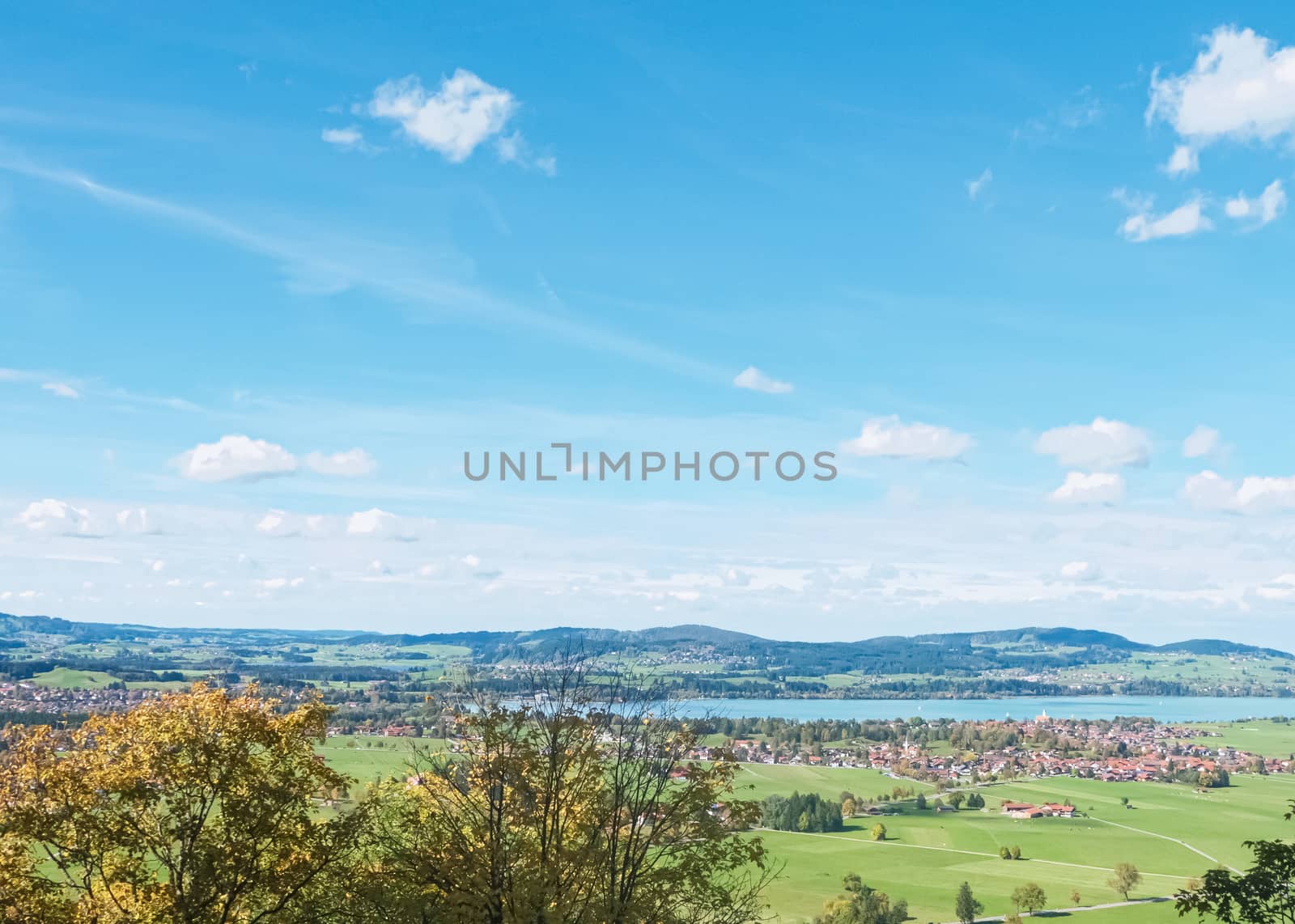 Beautiful nature of European Alps, landscape view of alpine mountains, lake and village on a sunny day, travel and destination scenery