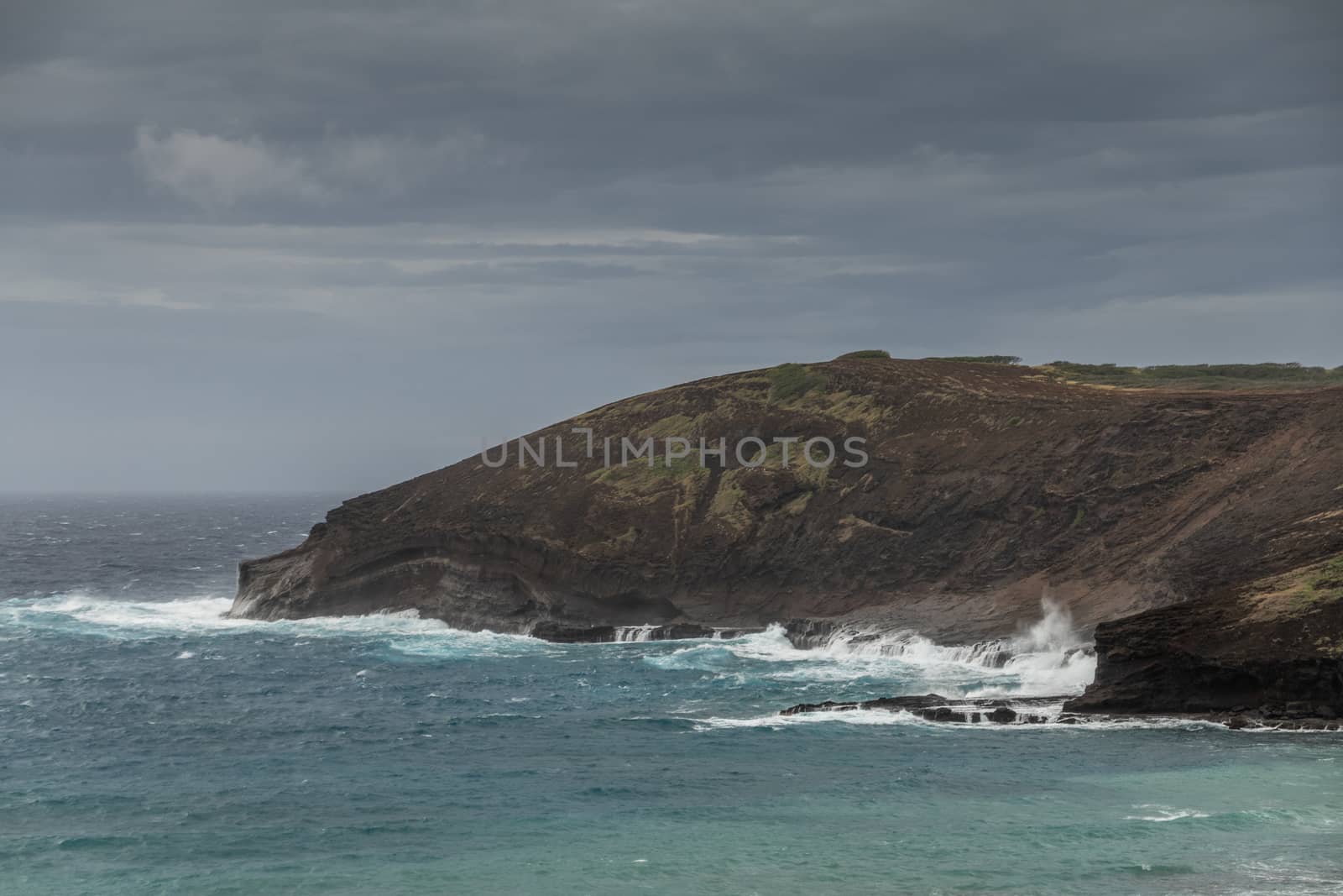 Hanauma Bay under storm clouds with Baboon face cliff,  Oahu, Ha by Claudine