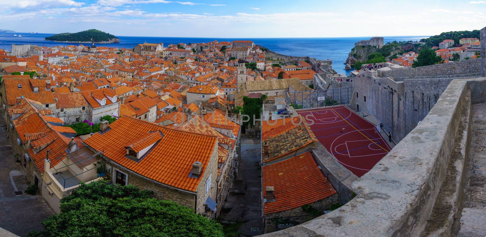 DUBROVNIK, CROATIA - JUNE 26, 2015: Panoramic view of the old city and Lokrum Island, with locals and tourists, in Dubrovnik, Croatia