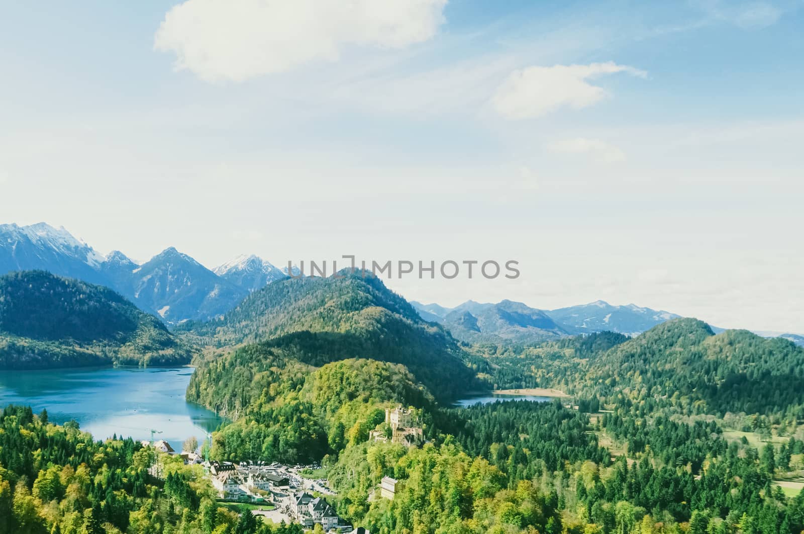 Beautiful nature of European Alps, landscape view of alpine mountains, lake and village in spring season, travel and destination scenery