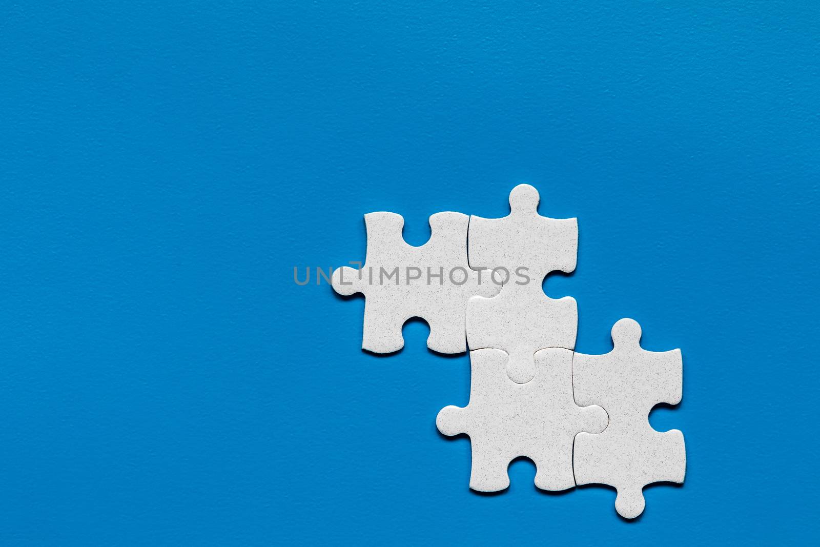 Closeup of jigsaw puzzle isolated. Missing jigsaw puzzle piece, business concept for completing the puzzle piece. Group of puzzle and a puzzle piece. Teamwork concept. Think difference concept. 