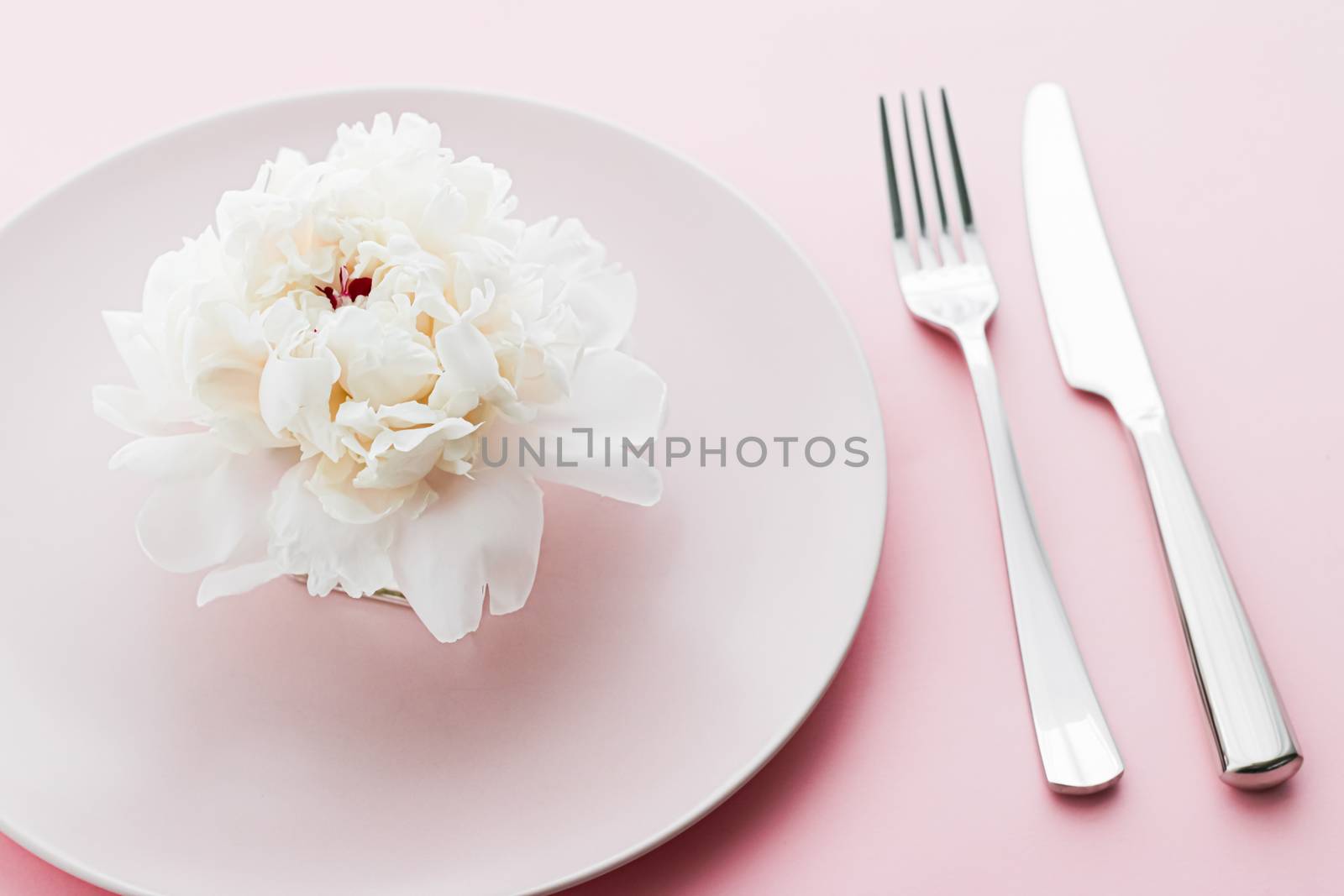 Dining plate and cutlery with peony flower as wedding decor set on pink background, top tableware for event decoration and dessert menu by Anneleven