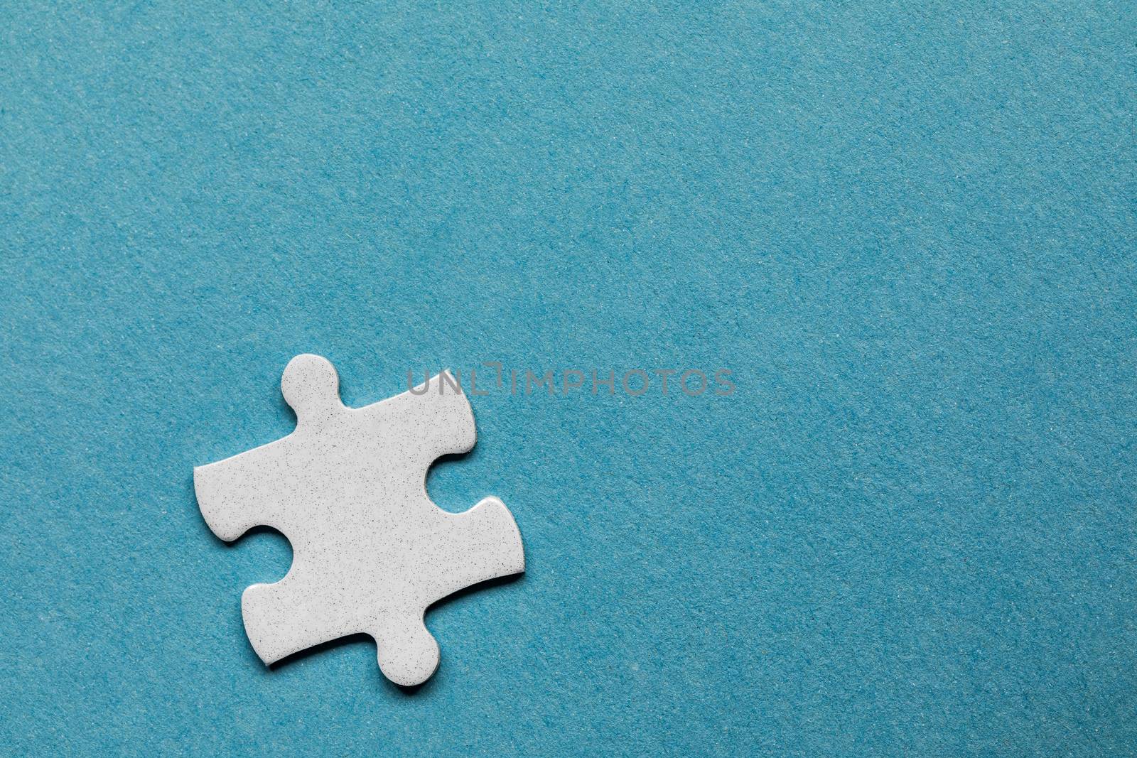 White jigsaw puzzle. White puzzle pieces on color background. Unfinished white jigsaw puzzle pieces on color background. 