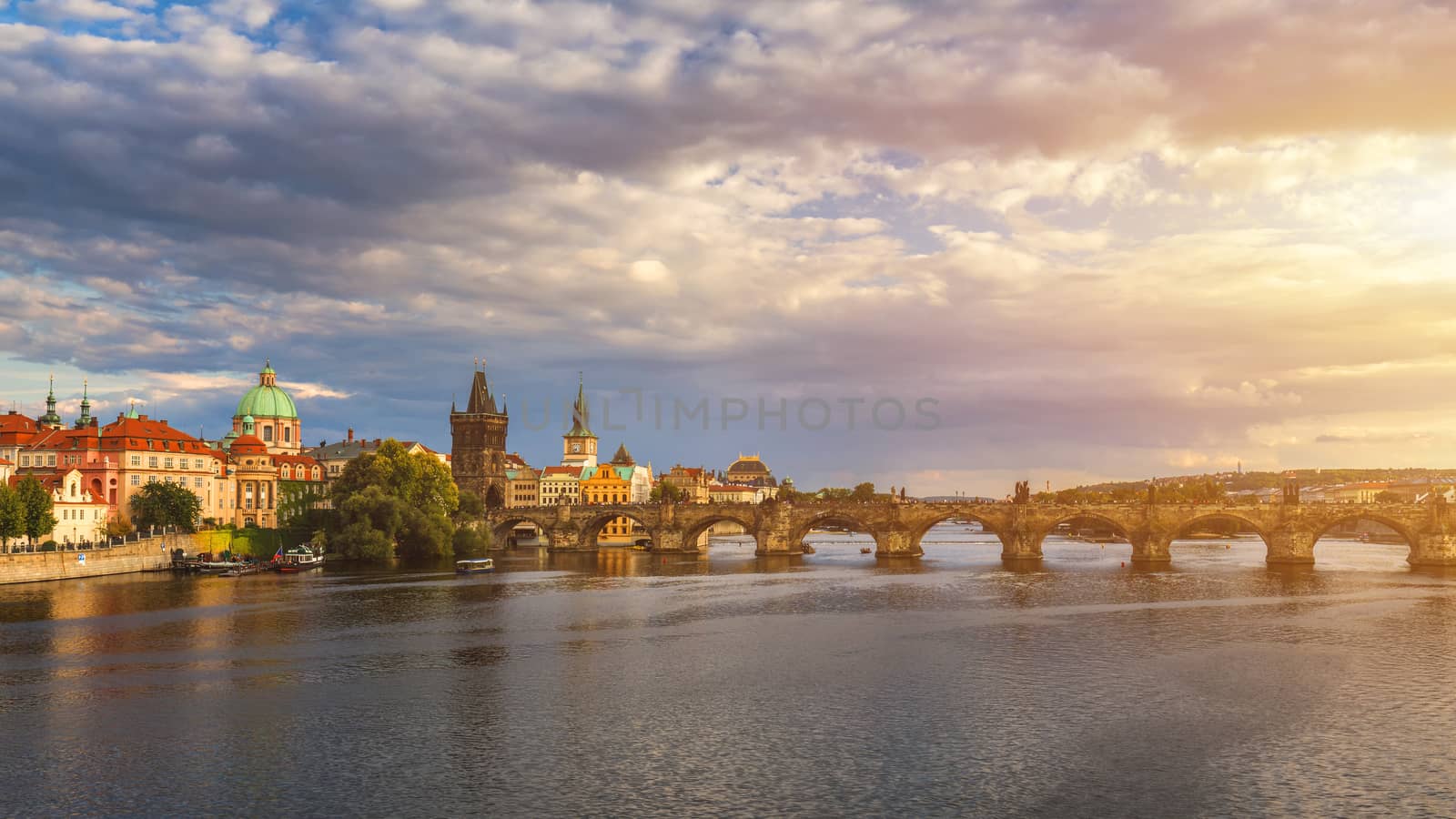 Prague, Czech Republic panorama with historic Charles Bridge and Vltava river on sunny day.