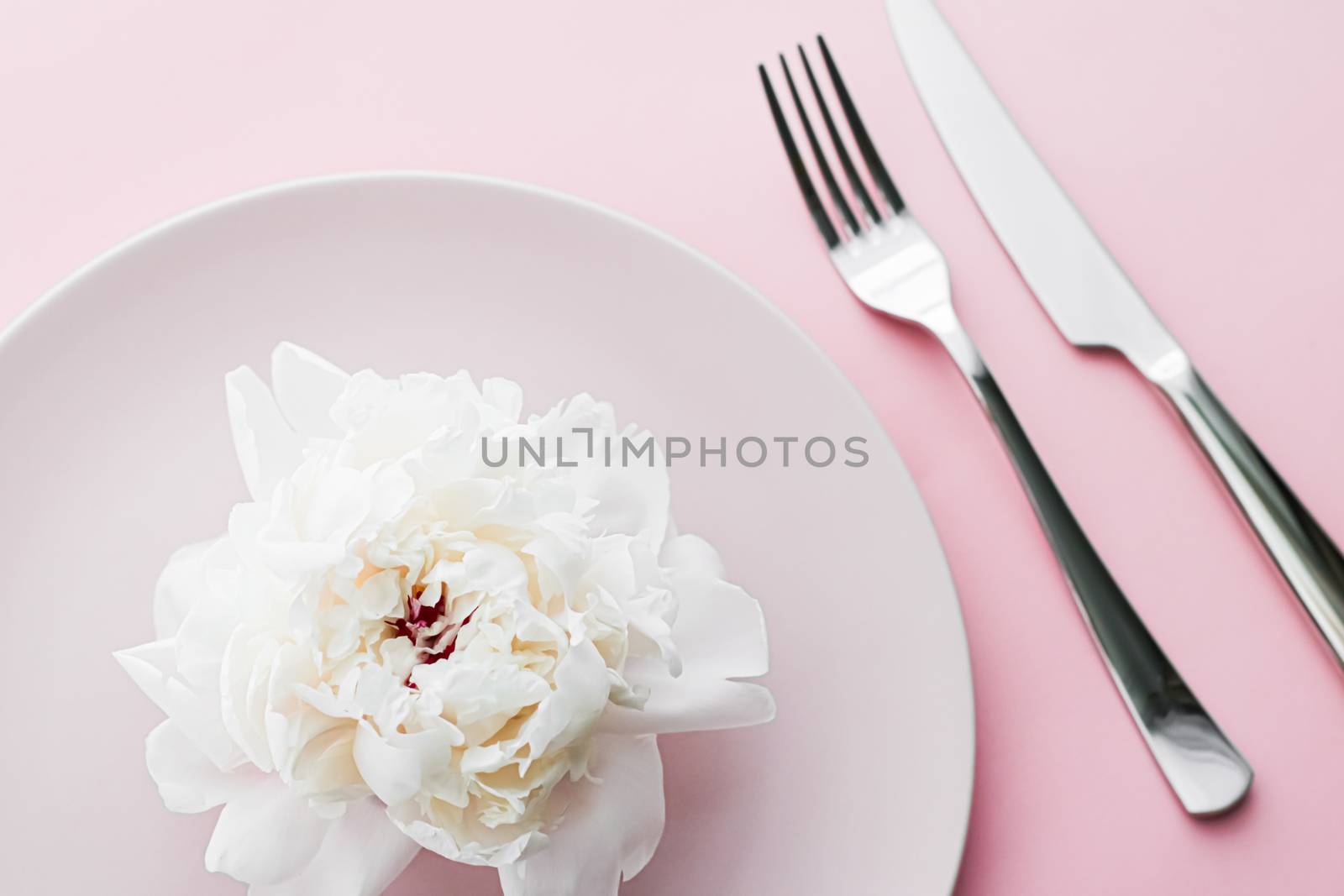 Dining plate and cutlery with peony flower as wedding decor set on pink background, top tableware for event decoration and dessert menu design