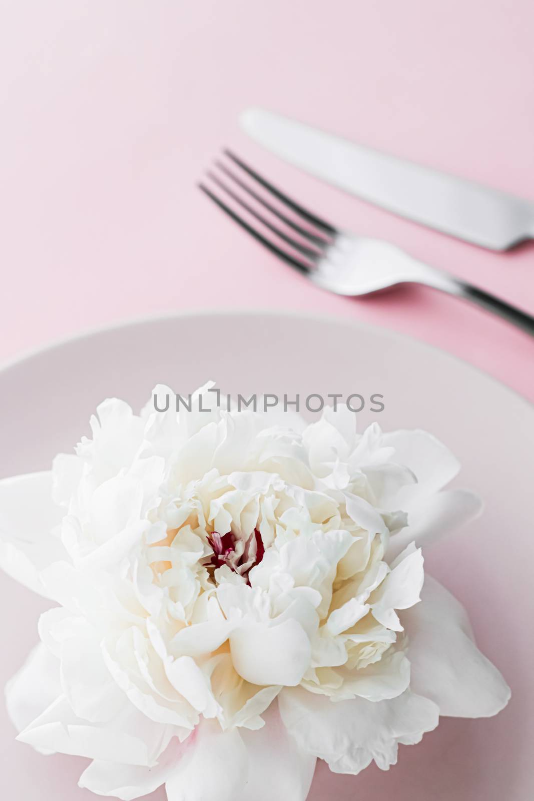 Dining plate and cutlery with peony flower as wedding decor set on pink background, top tableware for event decoration and dessert menu by Anneleven