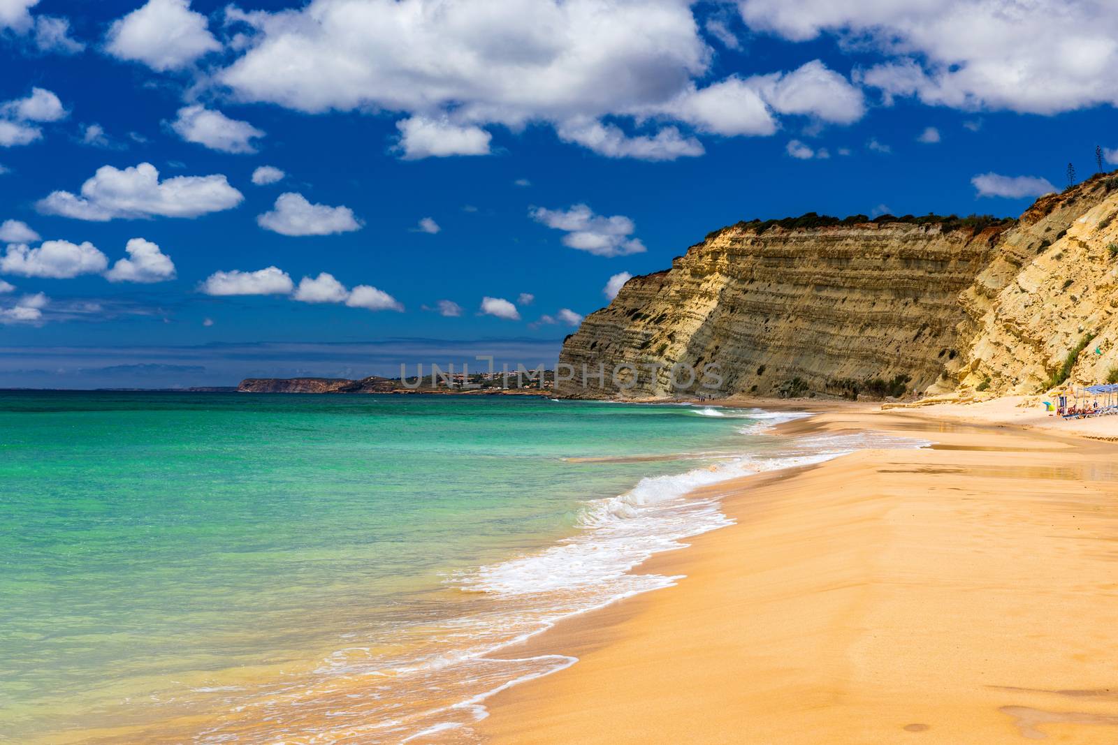 Praia de Porto de Mos in Lagos, Portugal. Praia do Porto de Mos, long beach in Lagos, Algarve region, Portugal. Beautiful golden beach, surrounded by impressive rock formations. 