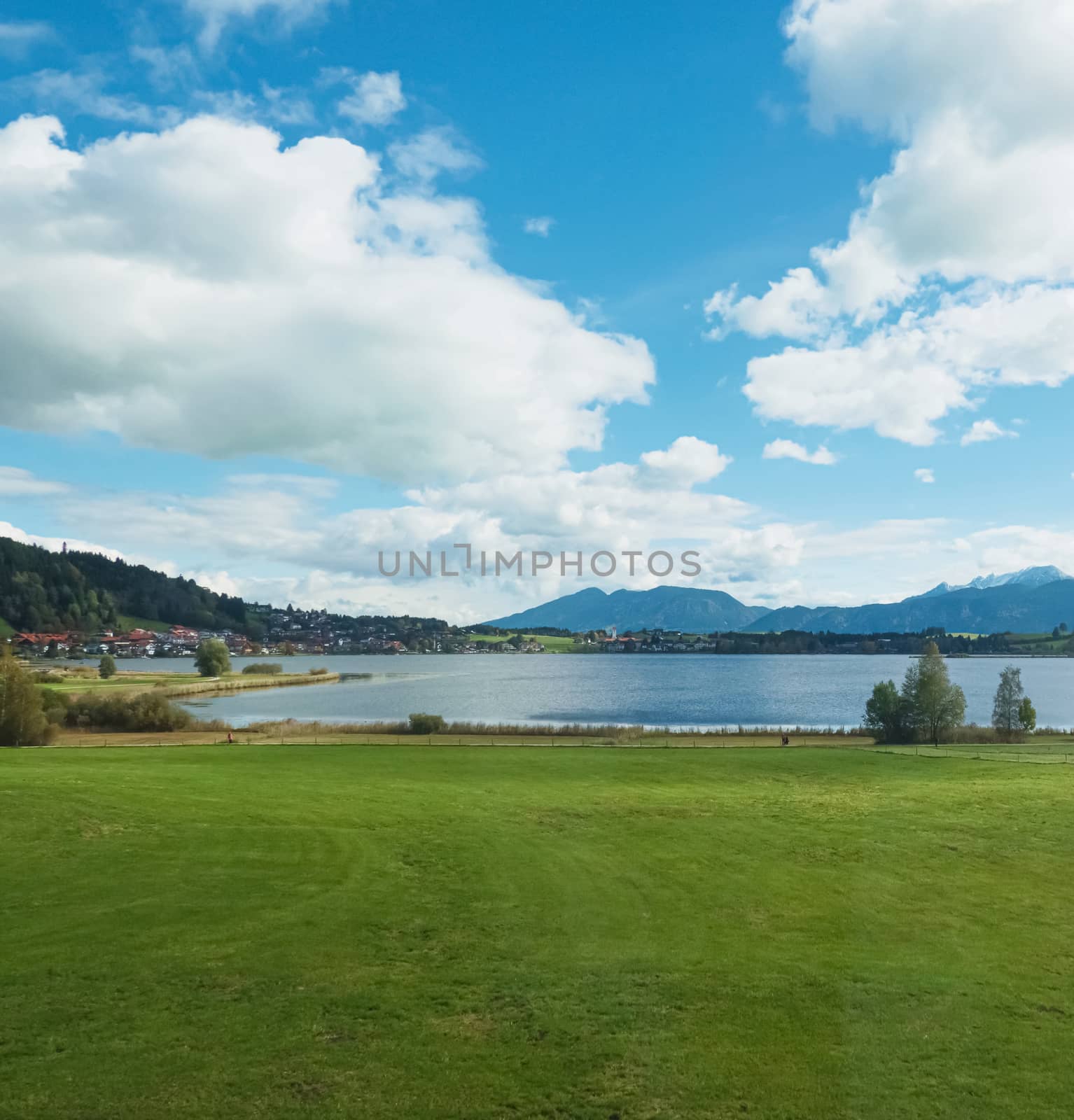 Beautiful nature of European Alps, landscape view of alpine mountains, lake and village on a sunny day, travel and destination by Anneleven