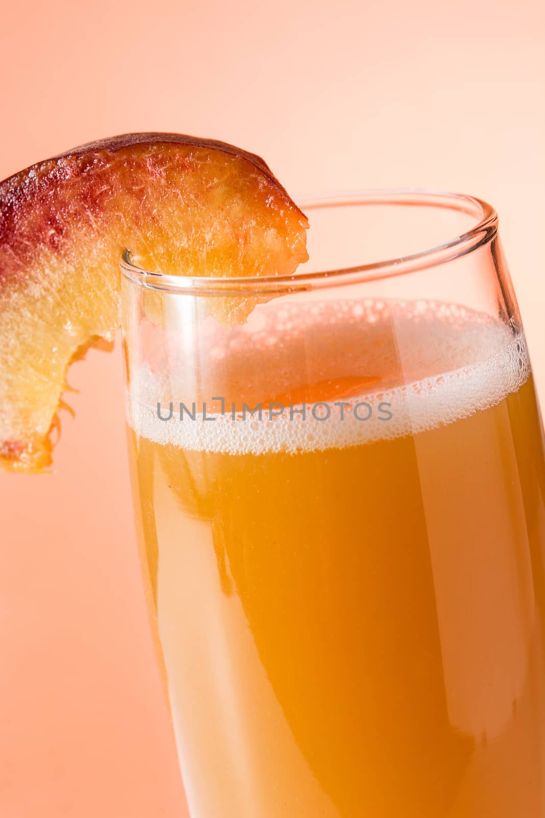 Bellini champagne cocktail on orange background