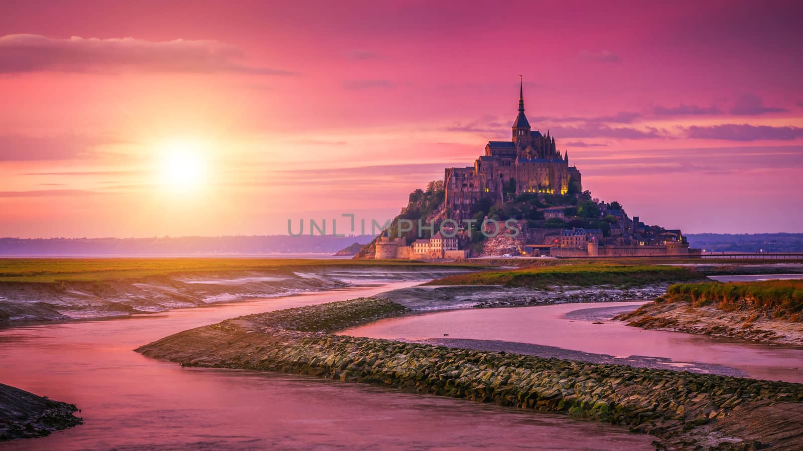 Panoramic view of famous Le Mont Saint-Michel tidal island at sunset, Normandy, northern France