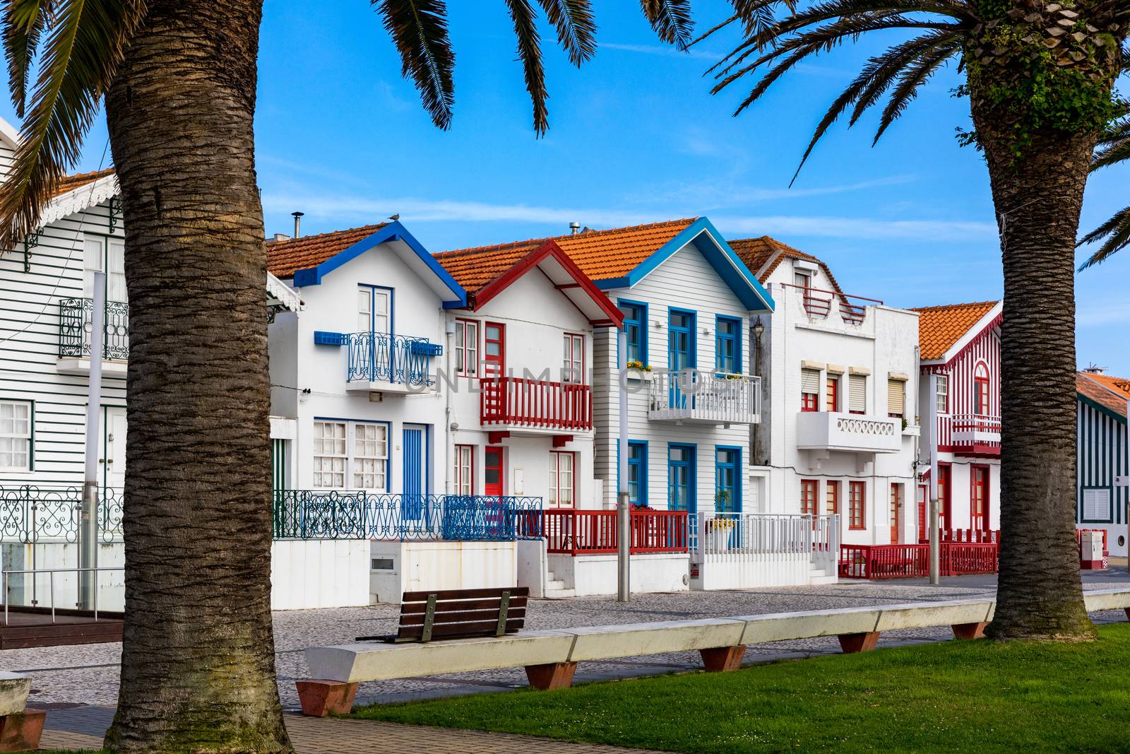 Street with colorful houses in Costa Nova, Aveiro, Portugal. Street with striped houses, Costa Nova, Aveiro, Portugal. Facades of colorful houses in Costa Nova, Aveiro, Portugal.