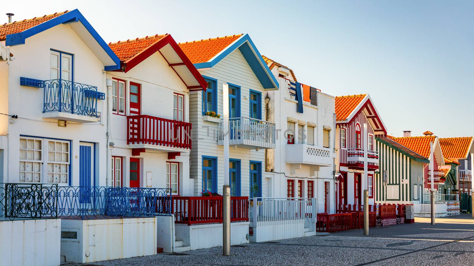 Street with colorful houses in Costa Nova, Aveiro, Portugal. Street with striped houses, Costa Nova, Aveiro, Portugal. Facades of colorful houses in Costa Nova, Aveiro, Portugal.