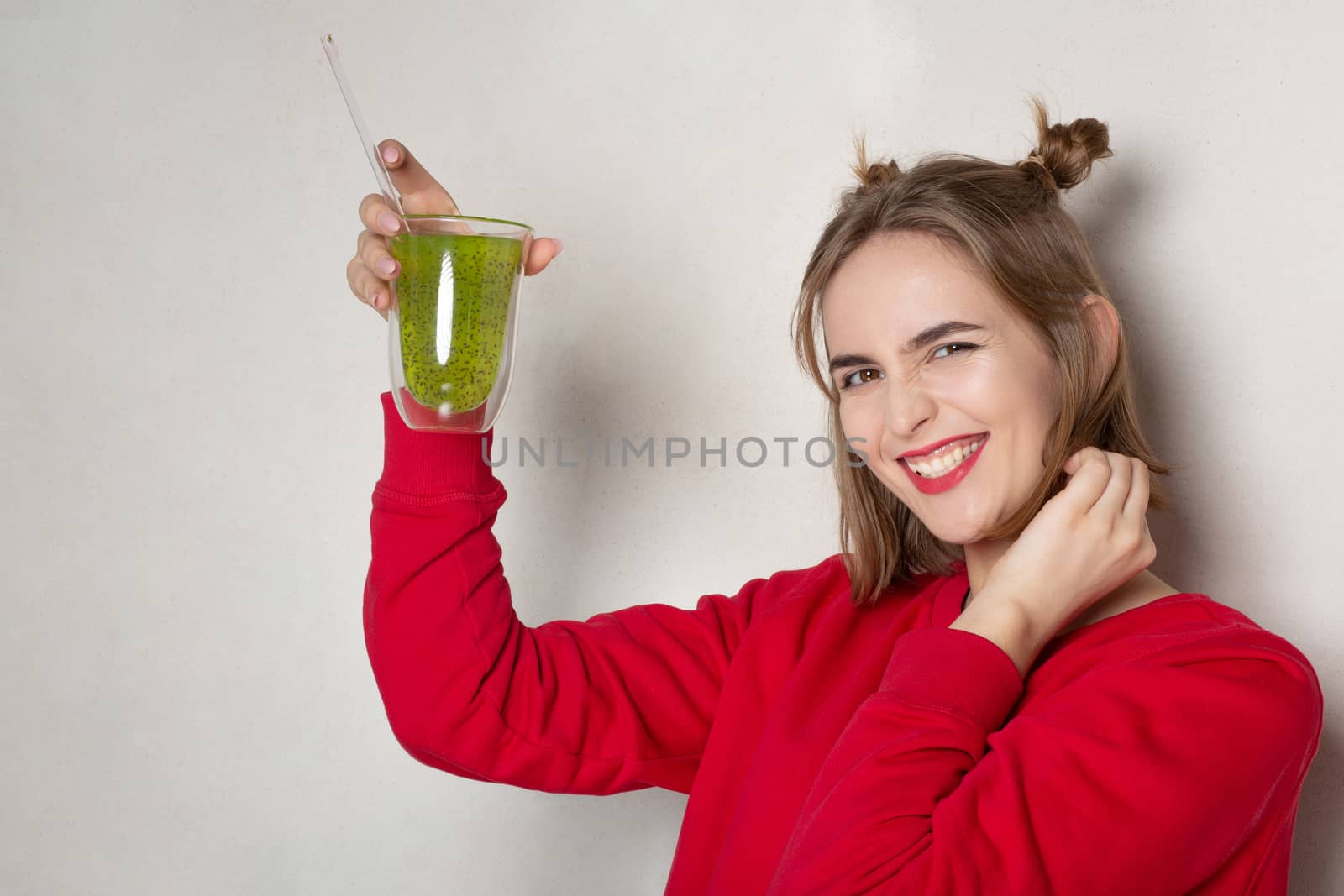 Cheerful girl holding glass of juice  by ViktoriiaPav