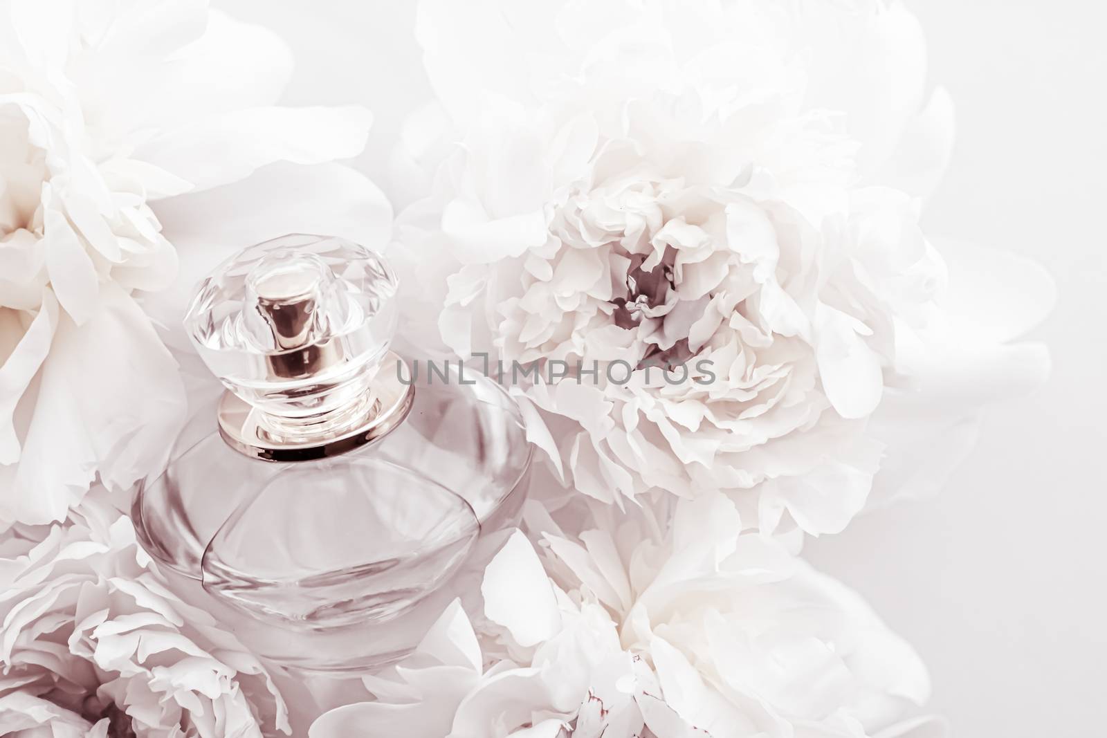 Chic fragrance bottle as luxe perfume product on background of peony flowers, parfum ad and beauty branding design