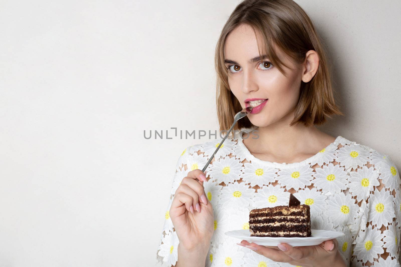 Thoughtful girl eating cake by ViktoriiaPav