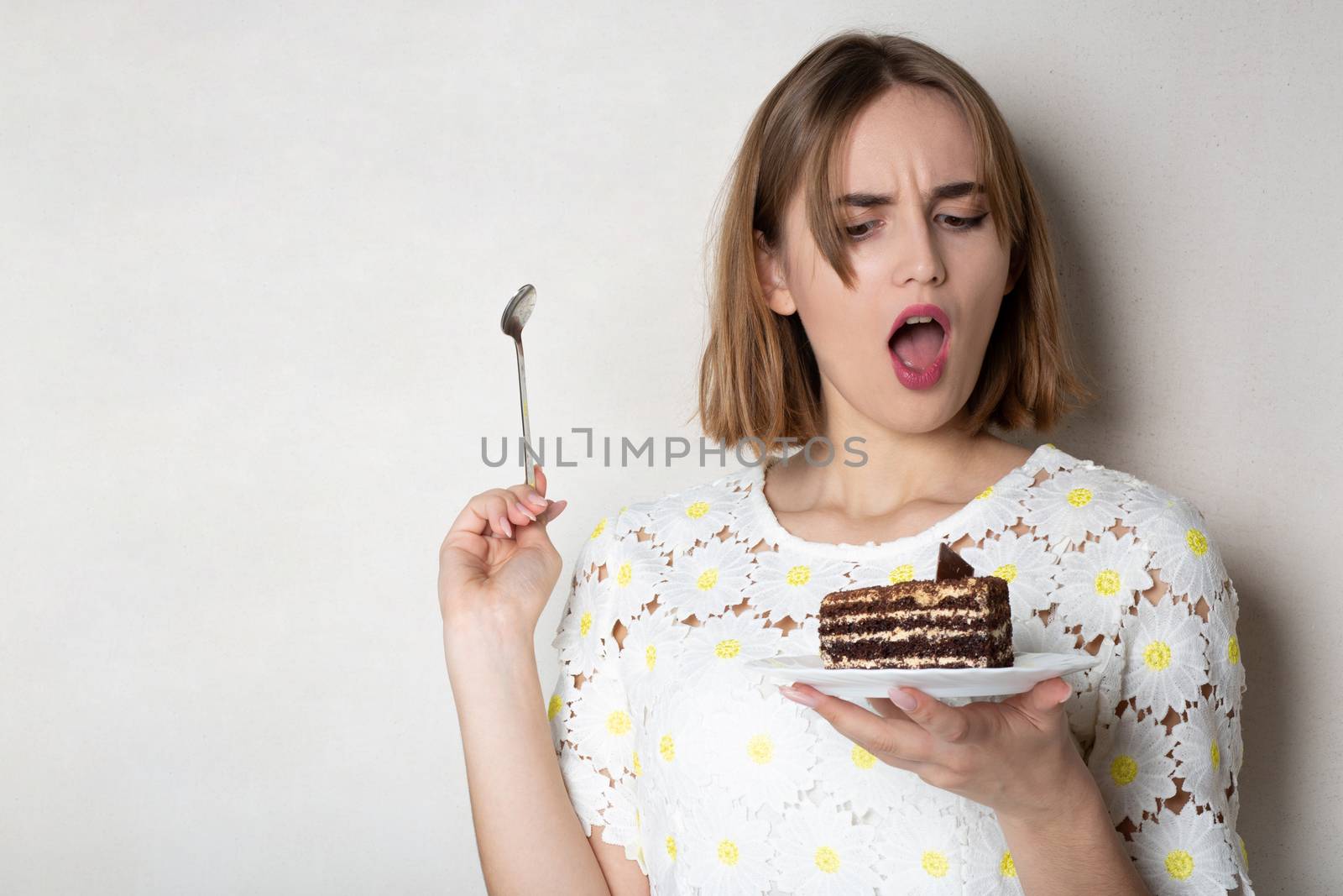 Displeased woman holding cake by ViktoriiaPav