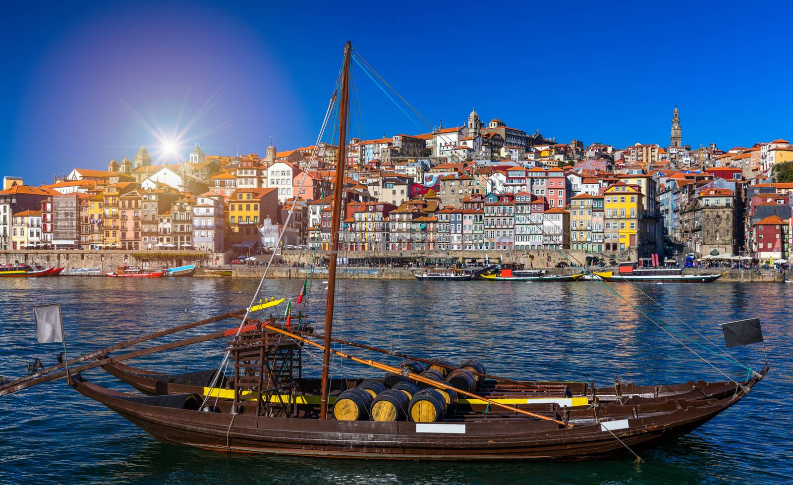 Port wine boats at the waterfront with the old town on the Douro River in Ribeira in the city centre of Porto in Porugal, Europe. Portugal, Porto