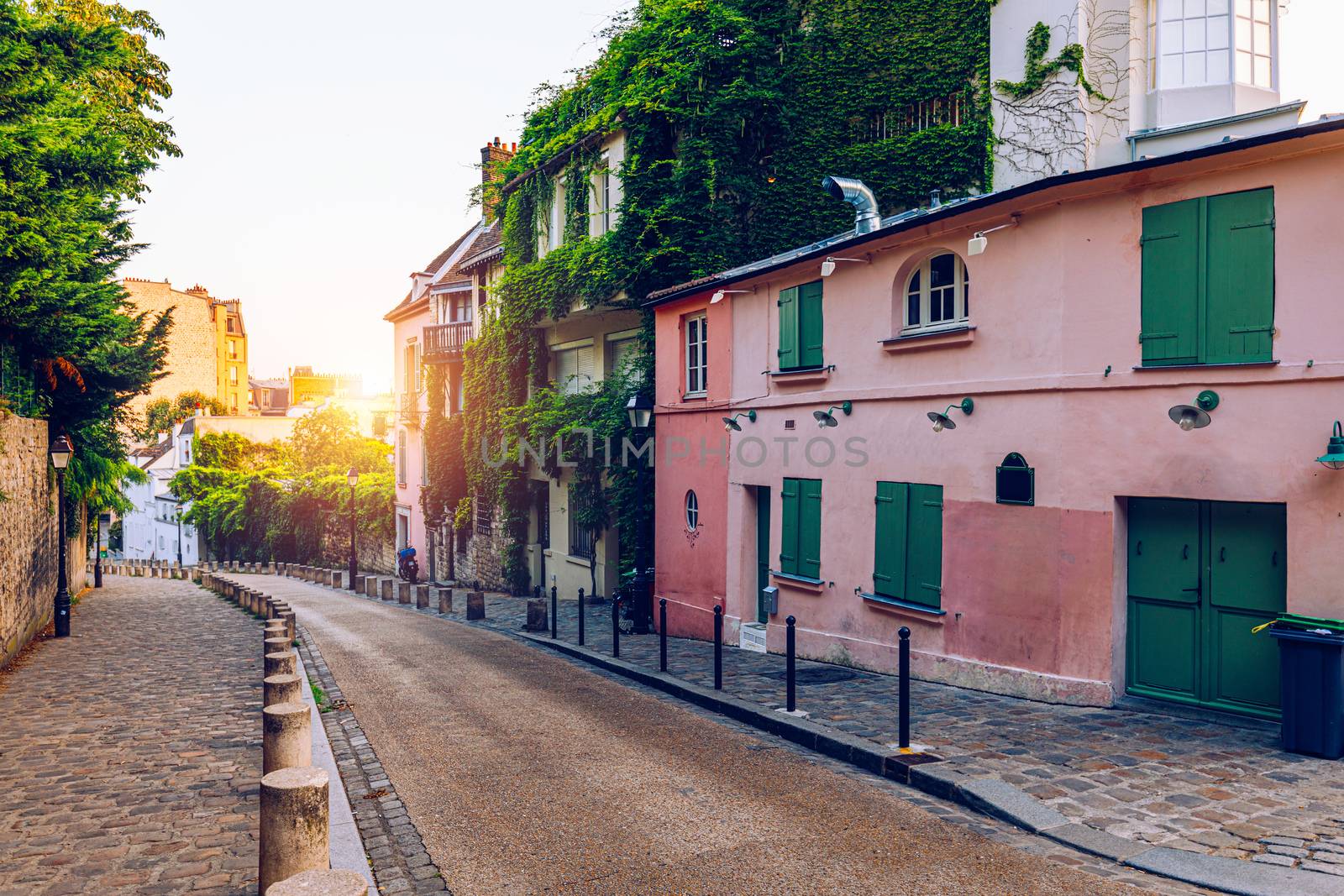 Montmartre district of Paris. Houses on narrow road in Montmartre district of Paris. View of cozy street in quarter Montmartre in Paris, France. Architecture and landmarks of Paris. Postcard of Paris.