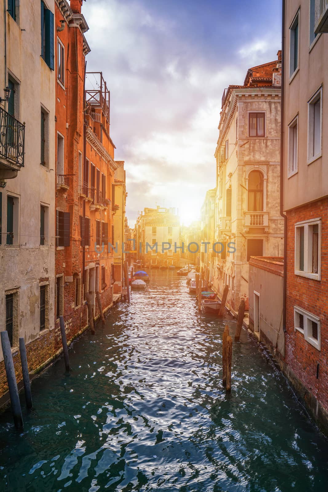 View of the street canal in Venice, Italy. Colorful facades of old Venice houses. Venice is a popular tourist destination of Europe. Venice, Italy.