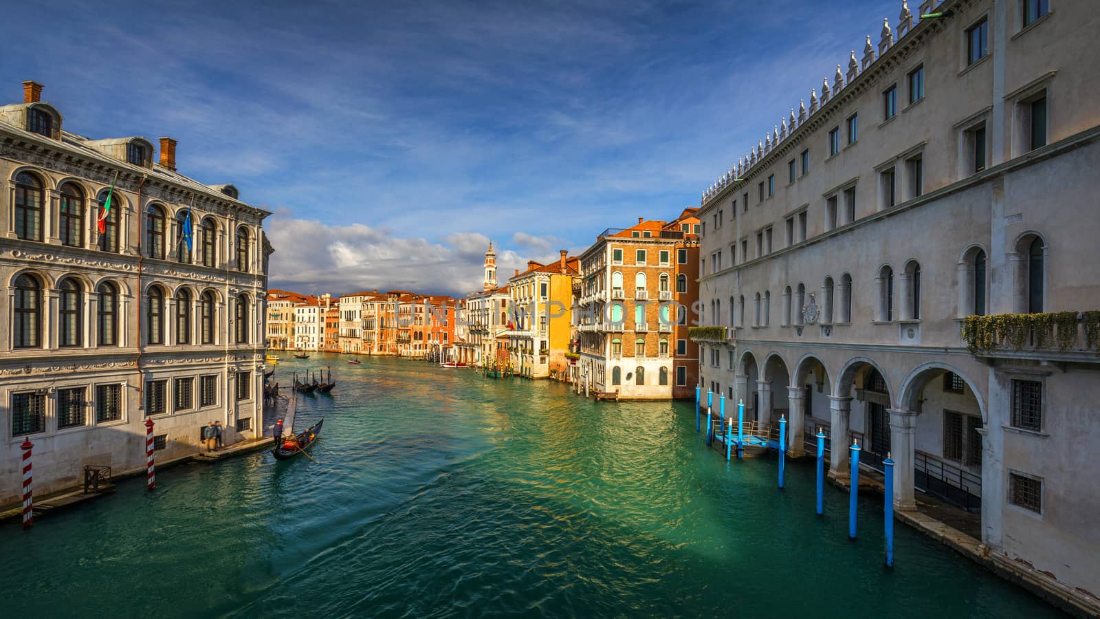 Street canal in Venice, Italy. Narrow canal among old colorful brick houses in Venice, Italy. Venice postcard