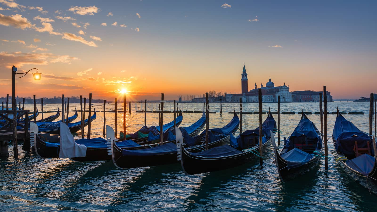 Canal with gondolas in Venice, Italy. Architecture and landmarks of Venice. Venice postcard with Venice gondolas.