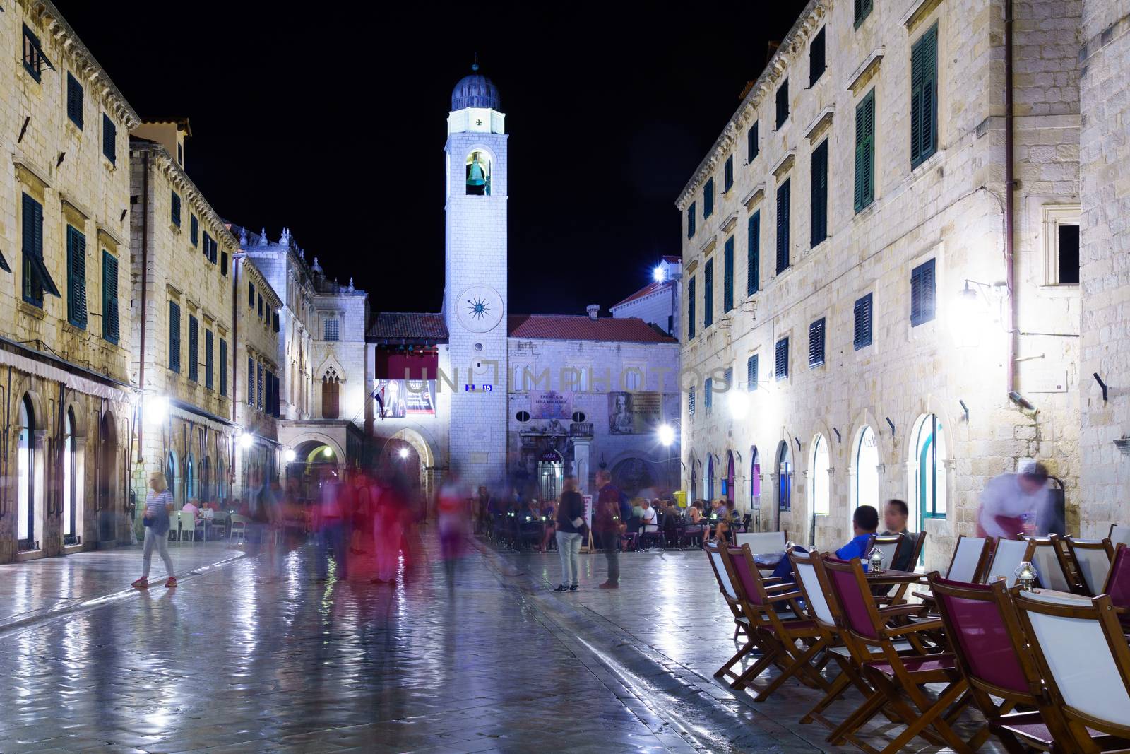 DUBROVNIK, CROATIA - JUNE 26, 2015: Night scene in the main street with Orlando's column, the bell tower, locals and tourists, in Dubrovnik, Croatia