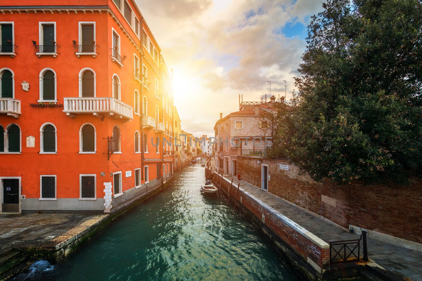 Street canal in Venice, Italy. Narrow canal among old colorful b by DaLiu