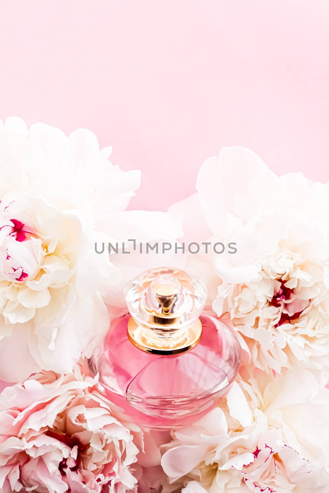 Luxurious fragrance bottle as chic perfume product on background of peony flowers, parfum ad and beauty branding design