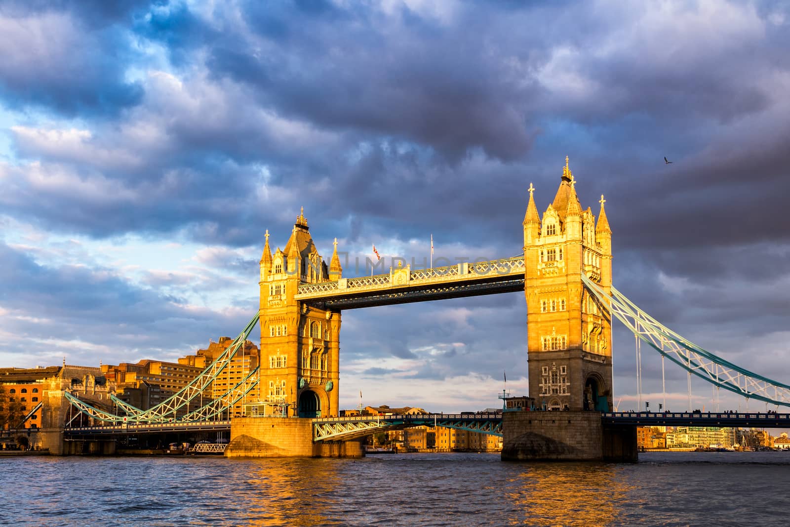 Tower Bridge with reflections at sunset in London, UK.