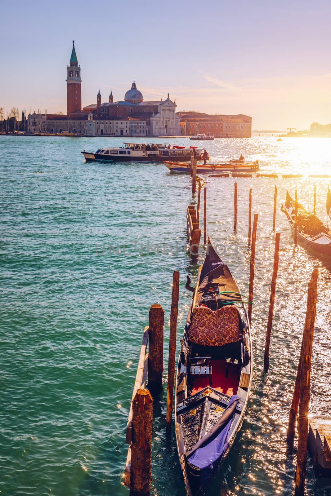 Gondolas moored near San Marco square across from San Giorgio Maggiore island in Venice, Italy. Gondolas were once the main form of transportation around the Venetian canals. Venice, Italy.