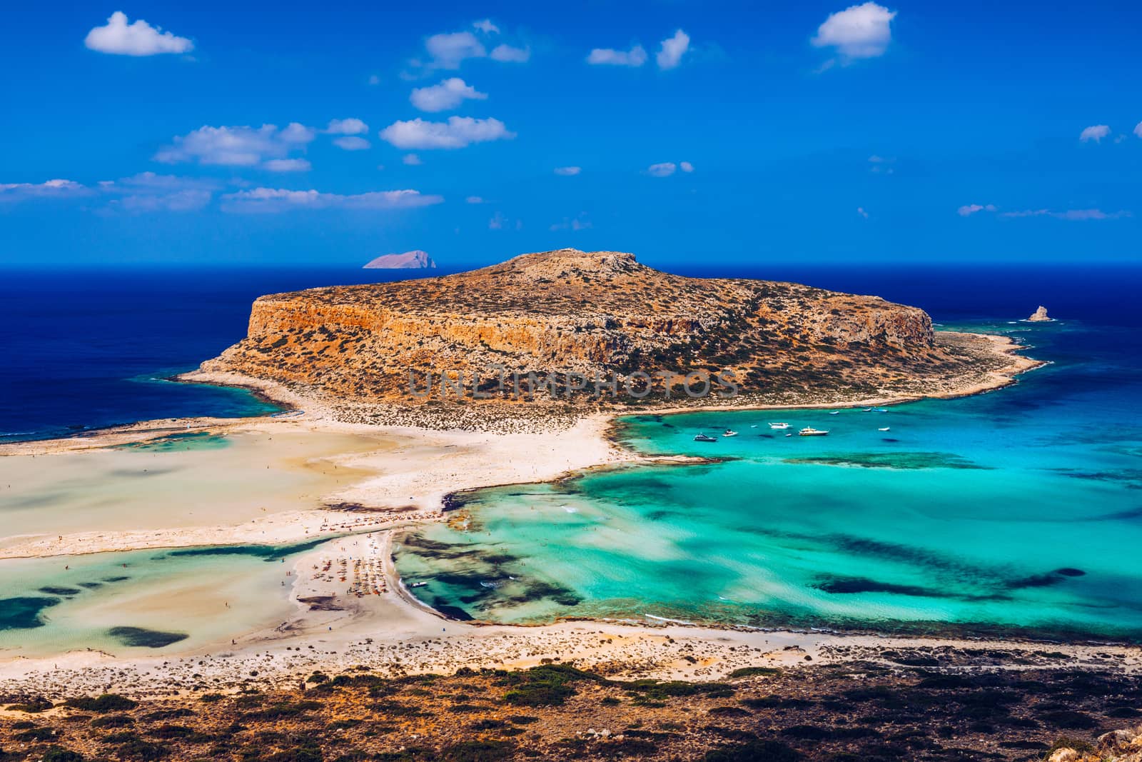 Fantastic panorama of Balos Lagoon and Gramvousa island on Crete, Greece. Cap tigani in the center. Balos beach on Crete island, Greece. Tourists relax and bath in crystal clear water of Balos beach.