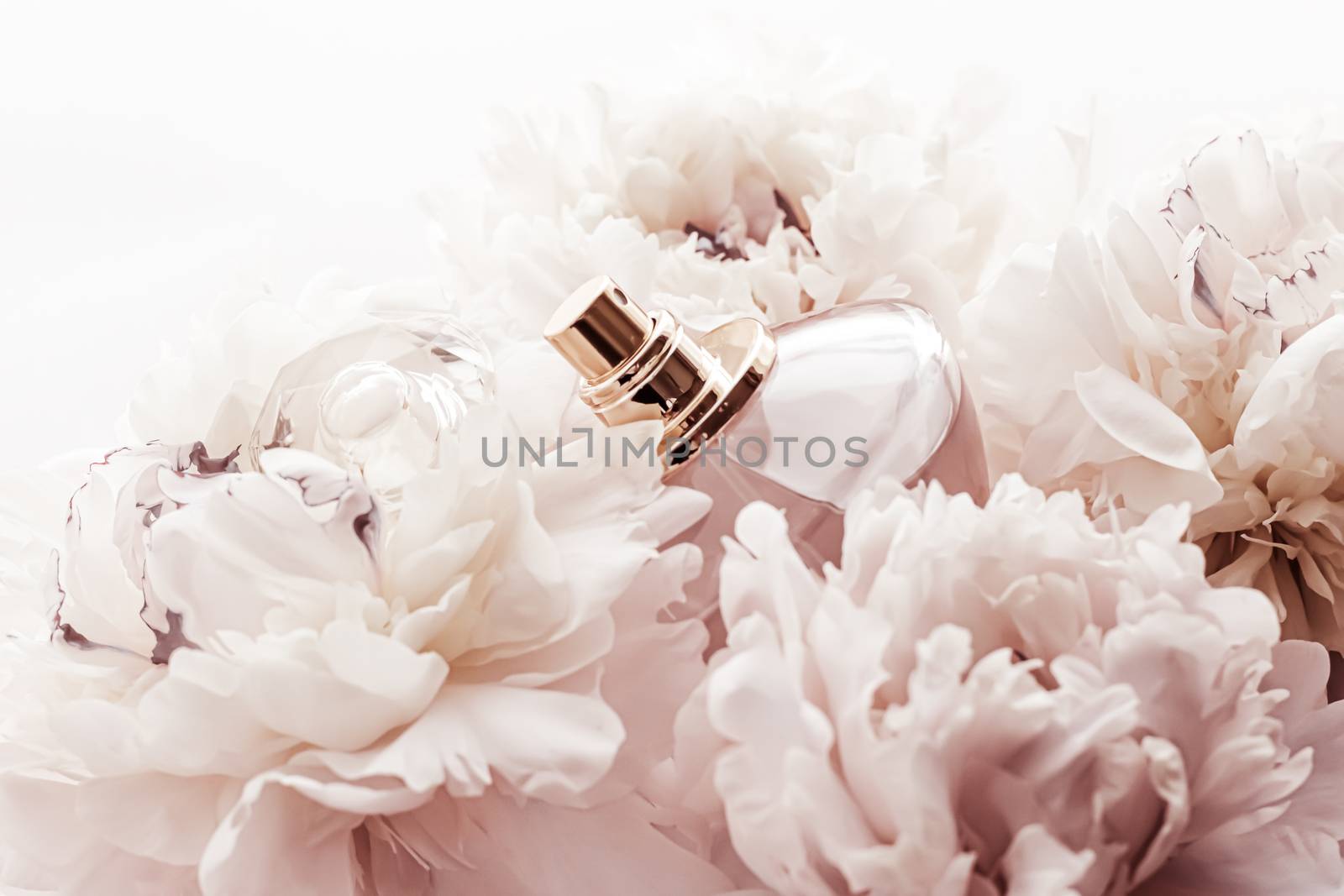 Fragrance bottle as luxury perfume product on background of peony flowers, parfum ad and beauty branding design