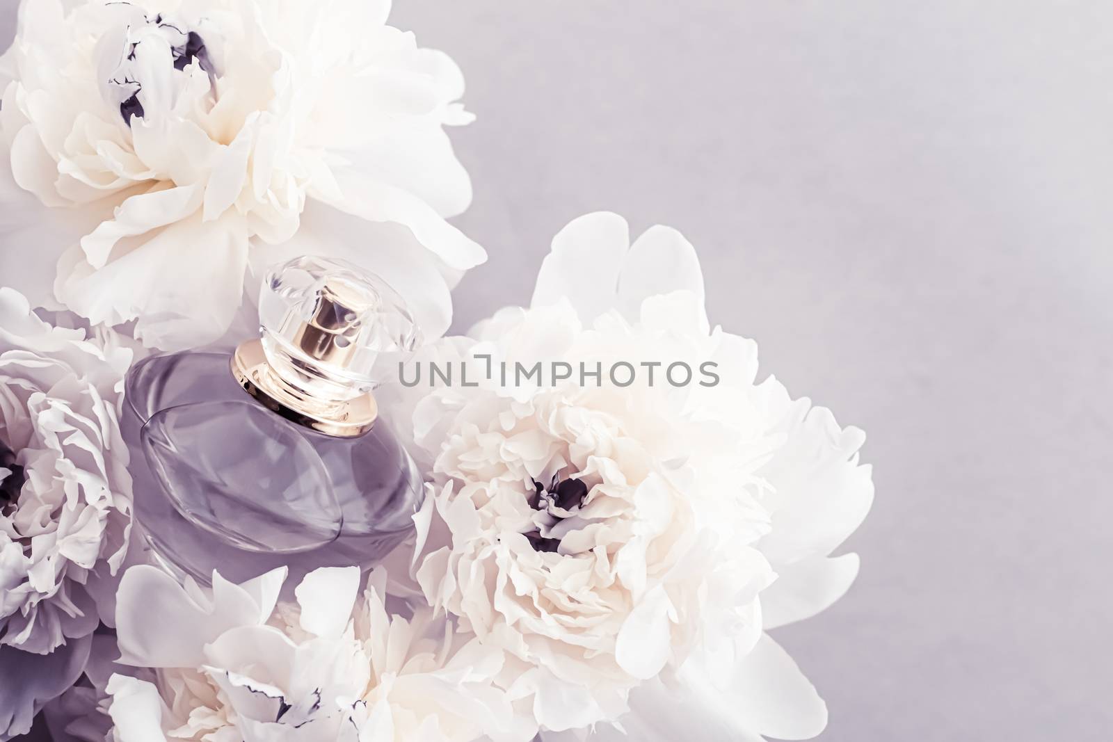 Violet fragrance bottle as luxury perfume product on background of peony flowers, parfum ad and beauty branding by Anneleven