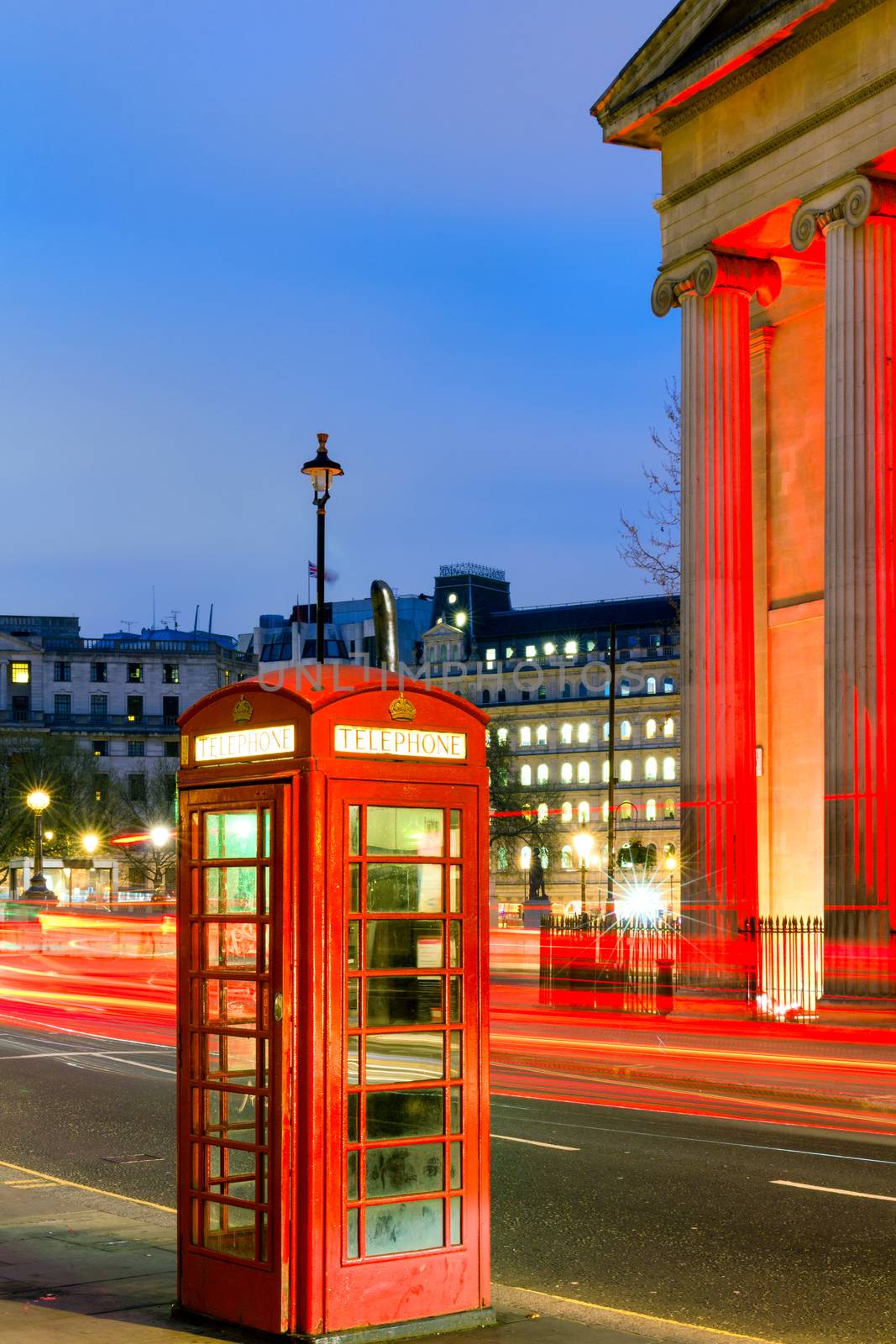 London Telephone box at night with streaming vehicle headlights