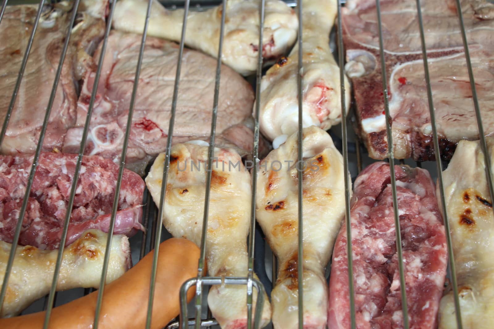 mixed meat grill with chicken and sausage cooked at barbecue