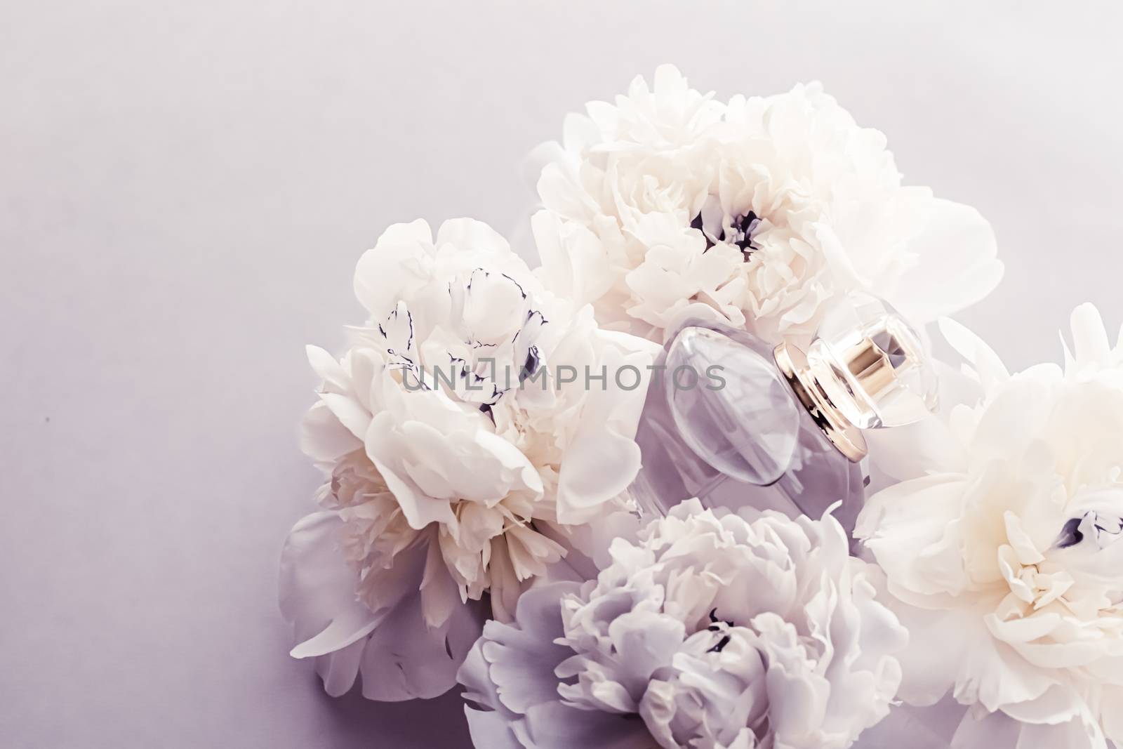 Violet fragrance bottle as luxury perfume product on background of peony flowers, parfum ad and beauty branding by Anneleven