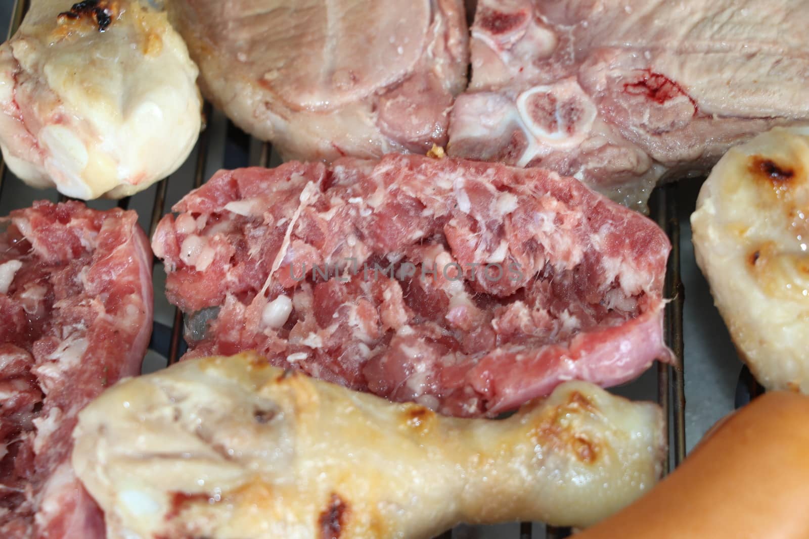 mixed meat grill with chicken and sausage cooked at barbecue