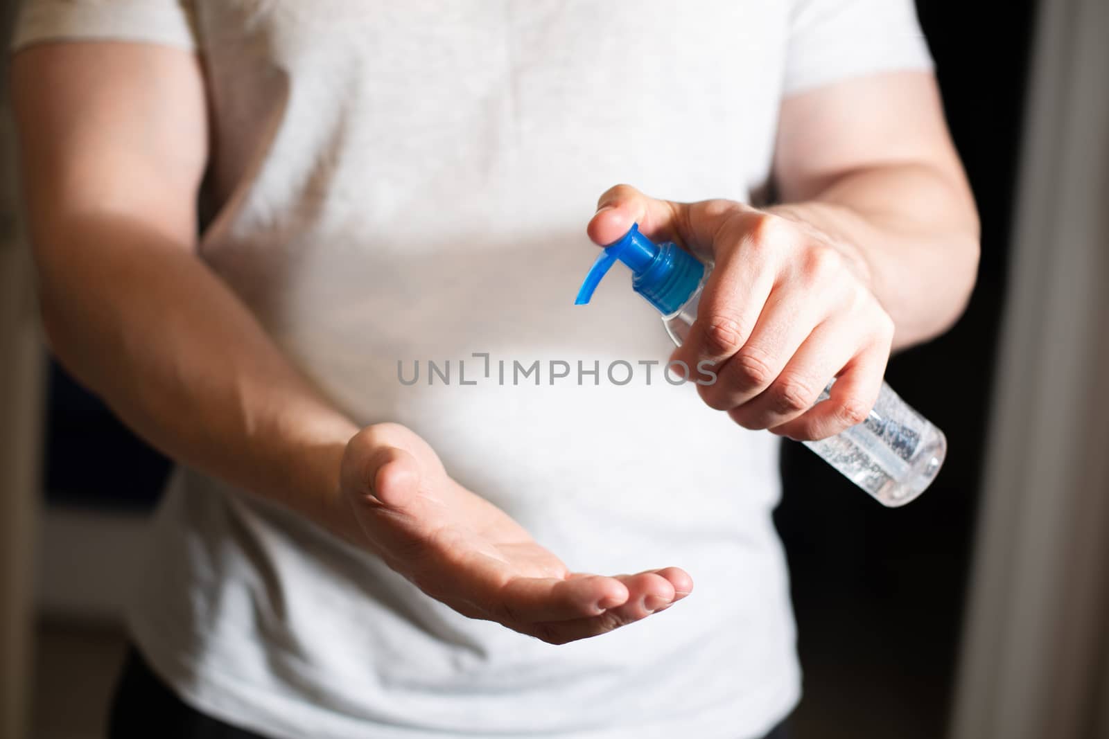 Man using antibacterial gel and cleans his hands